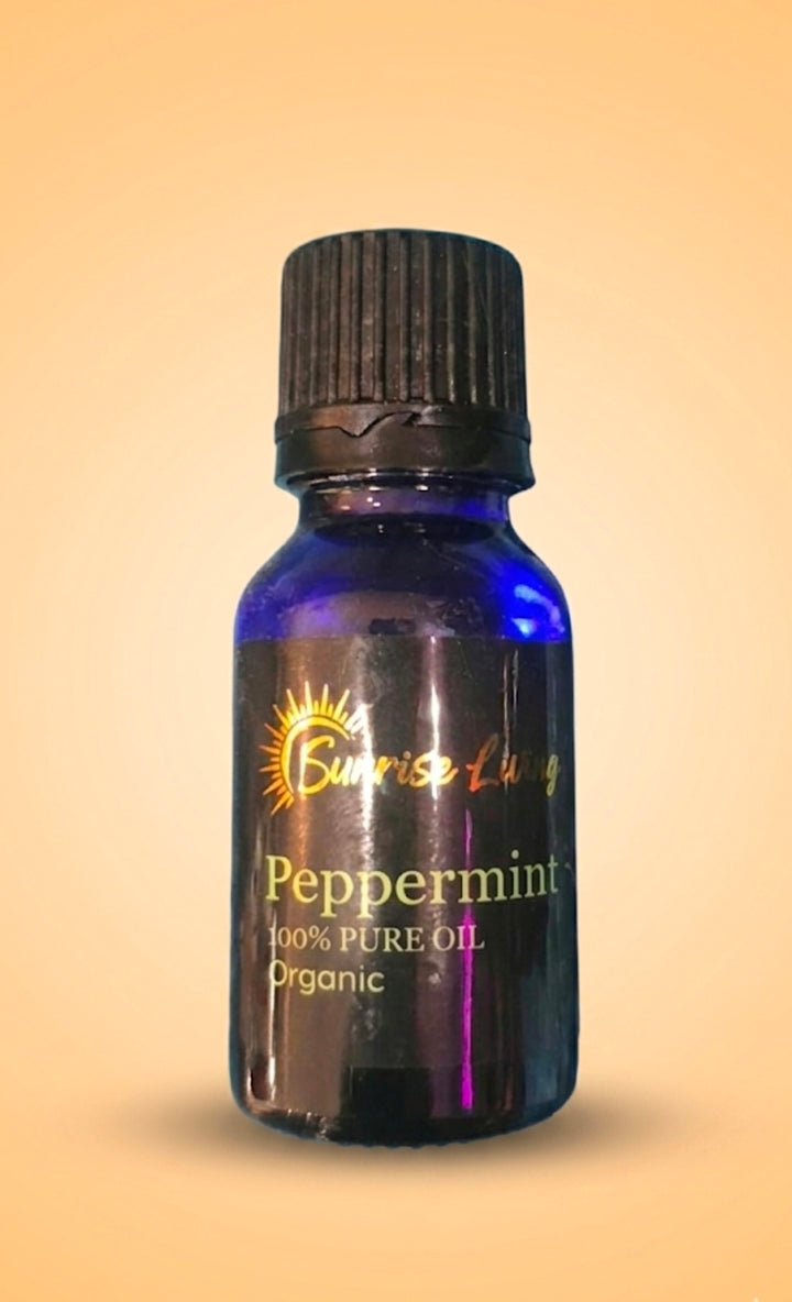 Peppermint essential oil bottle with black cap on a beige background